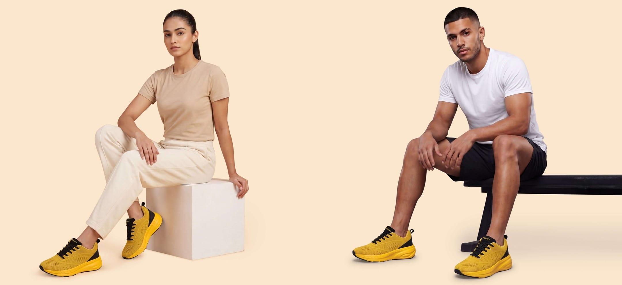 A sports-shoe brand campaign photograph - a woman and a man seated on a cream studio set, both wearing yellow cushioned running shoes - illustrating the sports-shoe category this Myntra price read covers under Rs. 3,000; the shoes shown are not among the picks
