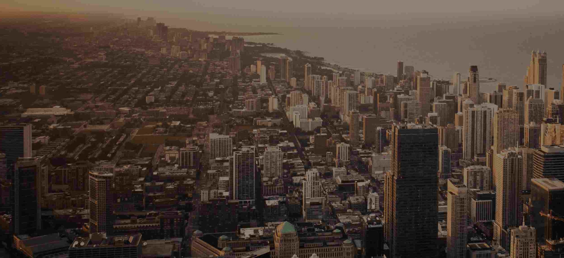 MakeMyTrip's own published offers-page travel photograph: an aerial view of a coastal city at sunset, brightened from the dimmed version MakeMyTrip ships - an international destination, matching the international flight offers the title leads with